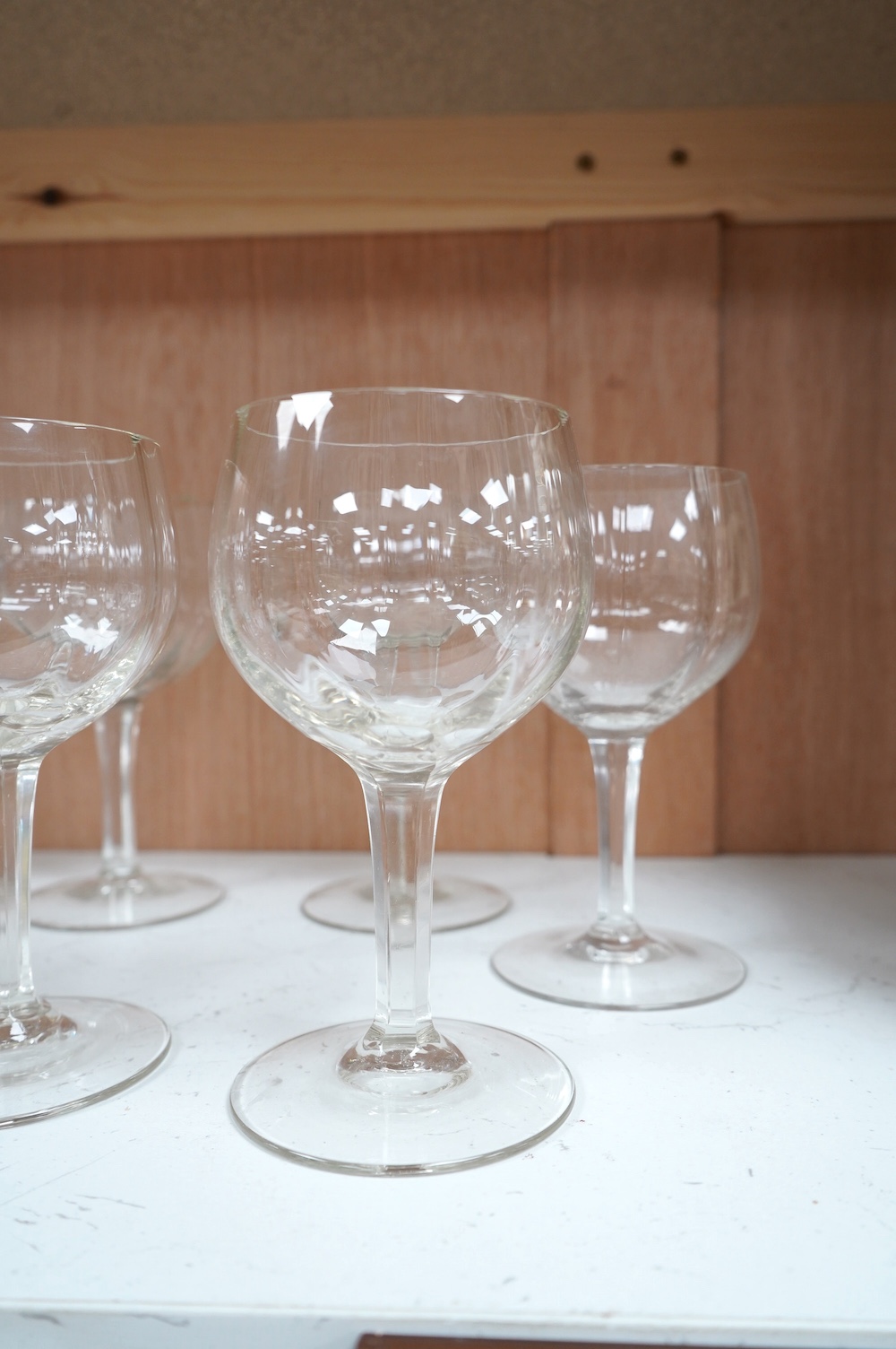 Three Baccarat (stamped) crystal ‘Massena’ cut glass wine goblets, a pair of late 19th century cut glass rummers and a set of six 20th century faceted wine glasses, Baccarat glasses 17.5cm high. Condition - good